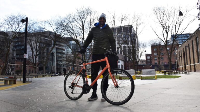 Tony Colley stands behind a bike on a snowy afternoon at St. Andrew’s Playground Park on March 20.