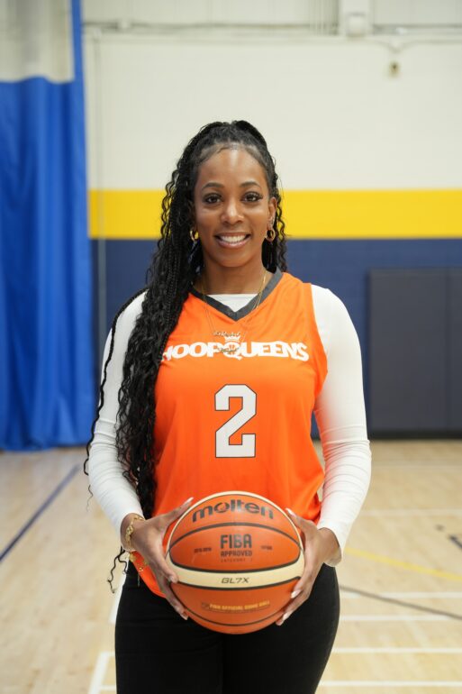 Angel Nuir with a hoop Queens jersey and FIBA basketball at Humber College