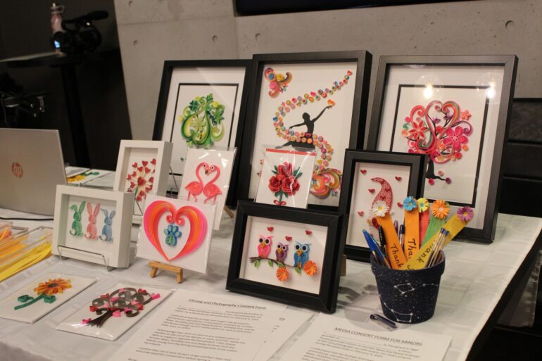 A table filled with paper quilling art designs.