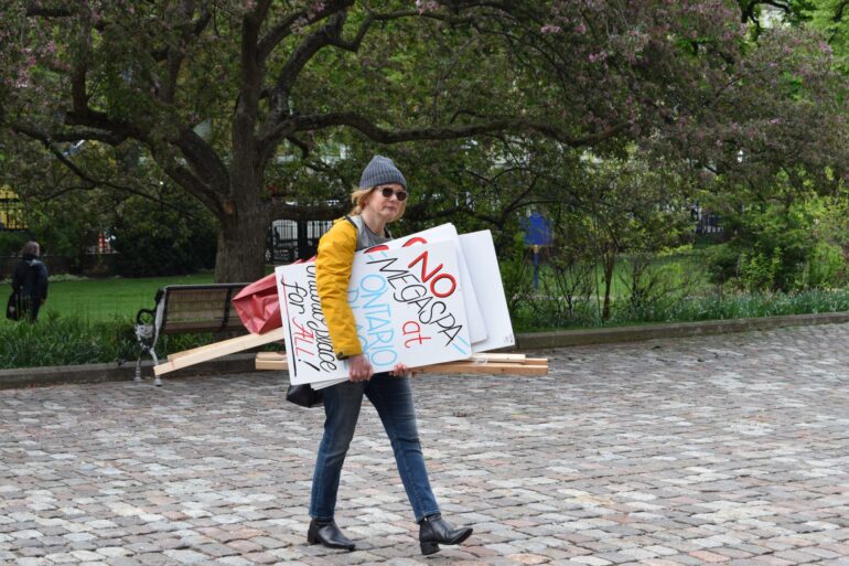 A photo of a supporter of Ontario Place 4 All walking to Osgoode Hall on Monday morning.