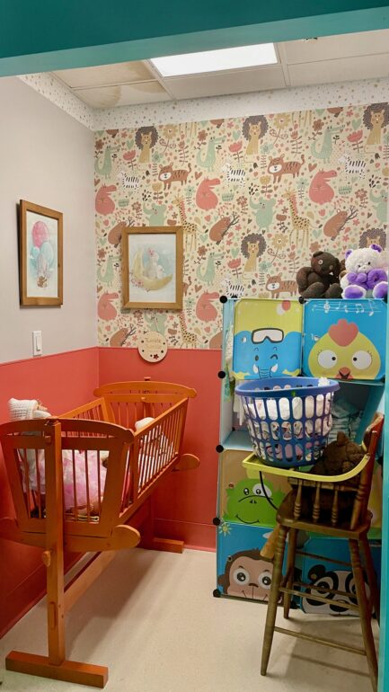 A storage closet became a nursery with a crib, stuffed toys, laundry and dolls for people staying at the Rekai Centre.