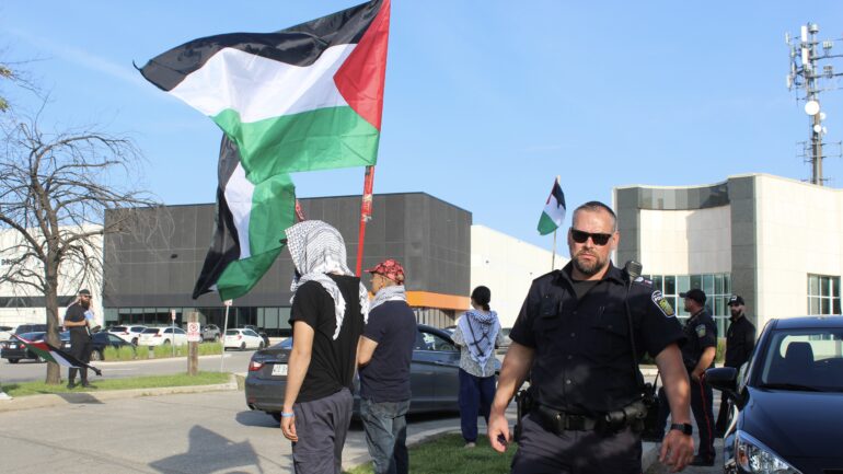 Protesters holding Palestinian flags at the protest site in Brampton outside the Banquet Hall where Miller&squot;s fundraiser was being held on June 3. Police officers were present at the site asking the protesters to step away from the "private property."